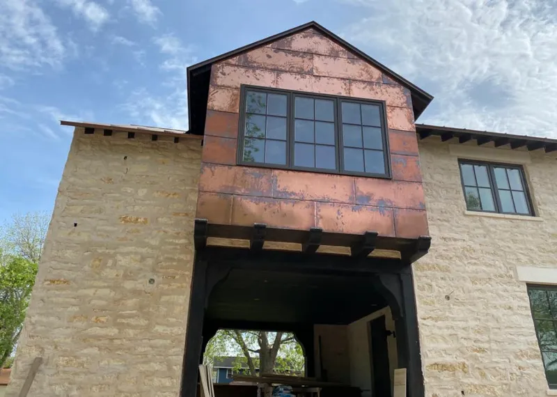 Copper metal panel facade on a stone building for Skylight Installation in Brown Deer